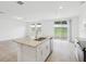 Open floor plan kitchen with granite counters, island, and stainless steel appliances at 2310 White Tail St, Davenport, FL 33837