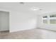 A minimalist living room with tile floors, recessed lights and bright windows at 2310 White Tail St, Davenport, FL 33837