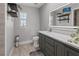 Bathroom with a modern vanity, illuminated mirror, and a window for natural light at 2466 R E Byrd Rd, Frostproof, FL 33843