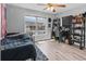 Bedroom featuring a large window, light wood flooring, and a ceiling fan at 2466 R E Byrd Rd, Frostproof, FL 33843