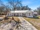 Attractive home with a metal roof and a welcoming front porch, complemented by well-maintained landscaping at 2466 R E Byrd Rd, Frostproof, FL 33843