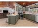 Spacious kitchen with shaker cabinets, stainless appliances, ample counter space, and an adjacent breakfast bar at 2466 R E Byrd Rd, Frostproof, FL 33843