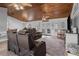 Comfortable living area with leather seating, a wood ceiling, and sliding glass doors leading to the exterior at 2466 R E Byrd Rd, Frostproof, FL 33843