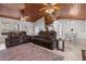 Inviting living area with a vaulted wood ceiling, neutral tile flooring, and comfortable leather seating at 2466 R E Byrd Rd, Frostproof, FL 33843