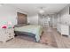 Bright main bedroom with a modern chandelier, barn door to ensuite, and ample closet space at 2466 R E Byrd Rd, Frostproof, FL 33843