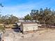 Aerial view showcases a detached garage, large lot, and covered patio of this country home at 2466 R E Byrd Rd, Frostproof, FL 33843