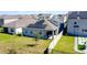 Back exterior featuring solar panels, well-kept lawn, fenced yard, and covered patio at 249 Hamlet Loop, Davenport, FL 33837