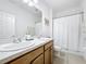 Bathroom features a double vanity, white shower curtain, toilet and tile flooring at 249 Hamlet Loop, Davenport, FL 33837