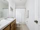 Bright bathroom featuring a vanity with sink, white shower curtain, and toilet at 249 Hamlet Loop, Davenport, FL 33837