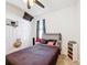This bedroom features a bed with a dark blanket, a ceiling fan and a window with black curtains at 249 Hamlet Loop, Davenport, FL 33837