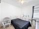 Bedroom features a bed with black bedding, a baby chair and a dresser at 249 Hamlet Loop, Davenport, FL 33837