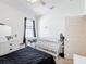This bedroom includes a crib and dresser with white drawers, providing space for a Bedroom at 249 Hamlet Loop, Davenport, FL 33837