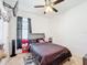 This bedroom features a ceiling fan, TV and a window with black curtains at 249 Hamlet Loop, Davenport, FL 33837