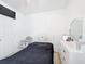 This bedroom features a bed with black bedding, a dresser and a door at 249 Hamlet Loop, Davenport, FL 33837