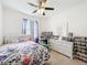 Bright bedroom with a ceiling fan, large window, and furnishings at 249 Hamlet Loop, Davenport, FL 33837
