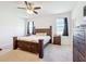 The bedroom features a dark wood frame bed, ceiling fan, two windows and a dresser at 249 Hamlet Loop, Davenport, FL 33837