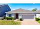 Charming single Gathering home featuring a brick walkway, well-maintained lawn, and a two-car garage at 249 Hamlet Loop, Davenport, FL 33837