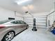 Spacious garage with a parked car and ample space for storage at 249 Hamlet Loop, Davenport, FL 33837
