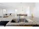 Kitchen island offers a sink and ample counter space with an open view to the living and dining areas at 249 Hamlet Loop, Davenport, FL 33837