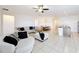 Open living area featuring neutral walls, tile floors, comfortable sofas, and a dining nook at 249 Hamlet Loop, Davenport, FL 33837