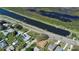 An aerial view of homes alongside a canal and waterway, showcasing the neighborhood's waterfront access at 25 Lakeshore Blvd, St Cloud, FL 34769