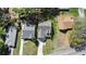 Aerial view of community featuring well-maintained lawns and mature trees near a quiet street at 25 Lakeshore Blvd, St Cloud, FL 34769