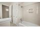 Bright bathroom featuring a shower-tub combo, white cabinets, and light neutral walls at 25 Lakeshore Blvd, St Cloud, FL 34769