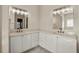 Well-lit bathroom featuring dual sinks, white cabinets, and neutral countertops at 25 Lakeshore Blvd, St Cloud, FL 34769