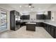 Bright kitchen with stainless steel appliances, gray cabinets, and an island at 25 Lakeshore Blvd, St Cloud, FL 34769