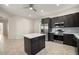 Modern kitchen features stainless steel appliances, gray cabinets, and an island at 25 Lakeshore Blvd, St Cloud, FL 34769