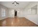 Spacious living room with hardwood floors, large windows, and access to the staircase at 25 Lakeshore Blvd, St Cloud, FL 34769