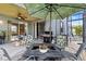 Covered patio offers comfortable outdoor living with a grill, seating, and lovely backyard views at 2933 White Cedar Cir, Kissimmee, FL 34741