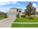 Charming two-story home featuring a well-maintained lawn, two-car garage, and inviting curb appeal at 2933 White Cedar Cir, Kissimmee, FL 34741