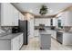 Bright and modern kitchen featuring white cabinets, a center island and stainless steel appliances at 2933 White Cedar Cir, Kissimmee, FL 34741