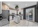 Bright and modern kitchen featuring white cabinets, a center island, stainless steel appliances and pool access at 2933 White Cedar Cir, Kissimmee, FL 34741