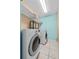 Functional laundry room featuring a washer and dryer with storage shelves, perfect for household chores at 2933 White Cedar Cir, Kissimmee, FL 34741