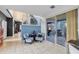 Open-concept living area with tile flooring, stairs, sliding door to outdoor patio, and cozy seating arrangement at 2933 White Cedar Cir, Kissimmee, FL 34741