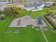 Aerial view of the community playground featuring swings, a slide, and seating areas on green lawns at 2933 White Cedar Cir, Kissimmee, FL 34741
