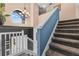 View of the home's carpeted staircase, white railing, and accent wall leading to the upper level at 2933 White Cedar Cir, Kissimmee, FL 34741