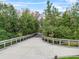 Scenic view of a wooden walking path surrounded by lush greenery and mature trees at 2933 White Cedar Cir, Kissimmee, FL 34741