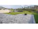 Large backyard with paver patio overlooking a pond and green space at 2984 Sanctuary Dr, Clermont, FL 34714