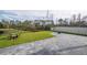 Well-manicured backyard with a stone-paved patio, lush lawn, and secure fencing for privacy and enjoyment at 2984 Sanctuary Dr, Clermont, FL 34714
