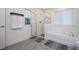 Bright bathroom featuring a glass enclosed shower and a soaking tub with a view at 2984 Sanctuary Dr, Clermont, FL 34714