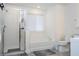 Bright bathroom with a combination shower and tub, featuring sleek glass doors and modern fixtures at 2984 Sanctuary Dr, Clermont, FL 34714