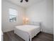 Bright bedroom featuring modern gray wood flooring, fresh white walls, and a cozy bed set at 2984 Sanctuary Dr, Clermont, FL 34714