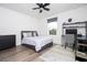 This bedroom features a ceiling fan, window, and a stylish desk for a comfortable and functional space at 2984 Sanctuary Dr, Clermont, FL 34714
