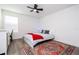 Bedroom features a ceiling fan, a window, and a colorful rug under the bed at 2984 Sanctuary Dr, Clermont, FL 34714