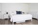 Inviting bedroom with a white wood bed frame, side tables, and dresser with luxury vinyl plank flooring at 2984 Sanctuary Dr, Clermont, FL 34714