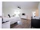 Spacious bedroom with hardwood flooring, lots of natural light, and a TV at 2984 Sanctuary Dr, Clermont, FL 34714