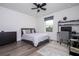 This bedroom features a ceiling fan, window, and a stylish desk for a comfortable and functional space at 2984 Sanctuary Dr, Clermont, FL 34714